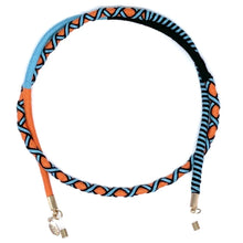 Load image into Gallery viewer, The Sichri "Rhapsody Orange" eyewear strap features a colorful, braided design with blue, black, and orange cotton-wrapped cords. Gold-tone attachments secure your sunglasses.