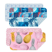 Load image into Gallery viewer, The Bobums Beach Towel Set for Two showcases two vibrant towels made from recycled materials: the top one has an abstract blue and red tropical design, while the bottom features a pink background with yellow and silver pineapples. Both include contrasting patterned linings.