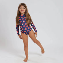 Load image into Gallery viewer, Breazies girls long sleeve swimsuit with red and white daisies on a navy background - front view shown on young girl with long hair