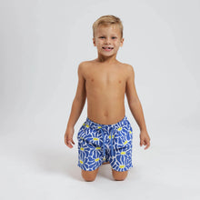 Load image into Gallery viewer, Breazies boys swim shorts with blue and yellow flowers - front view show on a model sitting on his knees
