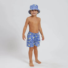 Load image into Gallery viewer, Breazies boys swim shorts with blue and yellow flowers - shown on young boy wearing a matching bucket hat