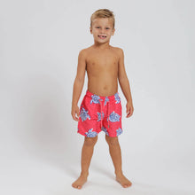 Load image into Gallery viewer, Breazies kids swim shorts with turtles on a coral red background - shown on young boy