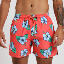 Load image into Gallery viewer, Breazies swim shorts for adults - hibiscus flower on orange background - front view on model