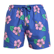 Load image into Gallery viewer, Breazies men swim shorts with pink hibiscus flower on a blue background - front view