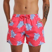 Load image into Gallery viewer, Breazies adult swim shorts with navy turtles on a coral red background - front view on a model