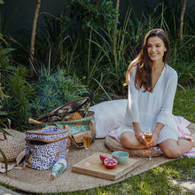 Load image into Gallery viewer, Lady having a picnic in the garden with her Thandana insulted picnic cooler bags.