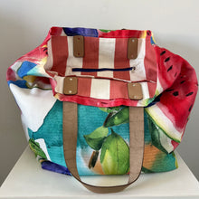 Load image into Gallery viewer, Binny Bag Watercolour fruit material tote bag, beach bag with leather handles and red striped fabric lining
