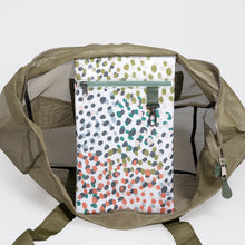 Load image into Gallery viewer, Introducing Thandana's Large Olive Mesh Beach Bag - Confetti, an open olive tote made from coated mesh with a zipper. Inside, a vibrant zippered pouch showcases multicolored dots on white. It's the perfect water-resistant companion for your beach adventures.
