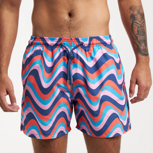 Load image into Gallery viewer, A person in Breazies Matching Retro Swimwear features wavy blue, red, pink, and purple patterns, a tied drawstring waist, and a left-arm tattoo. Made from recycled polyester for a stylish, sustainable look.