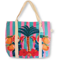 Load image into Gallery viewer, Example of a Beach Bag by Natural Selection with pink and teal stripes, two parrots on a palm tree with oranges and red flowers, beige handles, a waterproof lining, and a tassel for flair.