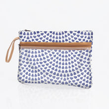 Load image into Gallery viewer, The Thandana Sticky Fingers Clear Pouch is a small, white, water-resistant pouch featuring a tan strap and zipper. It showcases blue teardrop-shaped dots in spiraling concentric circles on laminated fabric.