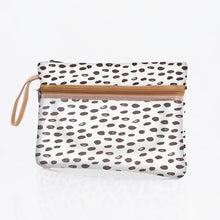 Load image into Gallery viewer, The Sticky Fingers Clear Pouch by Thandana is a rectangular clutch with a brown zipper and strap, featuring a black and white dotted pattern on PVC laminated fabric.