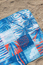 Load image into Gallery viewer, Corner close up of Microfibre towel with beach addict design and double sided pattern at La Mer beach