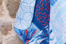 Load image into Gallery viewer, Close up of Microfibre towel with beach addict design and double sided pattern at Dubai Textile Souk