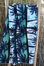 Load image into Gallery viewer, Bobums UAE Microfibre beach towel with Blue Palms Kids design on ladder in front of grass