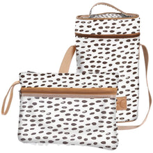 Load image into Gallery viewer, The Thandana &quot;Beachy Seeds&quot; collection includes two white bags with brown and black abstract dot patterns. The tall, rectangular bag serves as a wine cooler with handles and a strap, while the smaller laminated pouch has a wrist strap, zipper, and tan accents for style.
