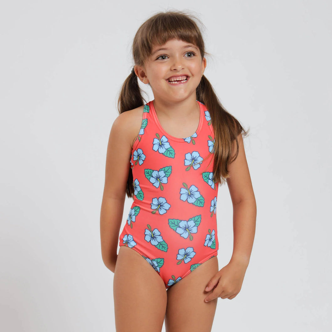 Breazies girls swimwear with hibiscus flower on an orange background- shown on a young girl.