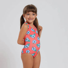 Load image into Gallery viewer, Breazies girls swimwear with hibiscus flower on an orange background- shown on a young girl - side view.
