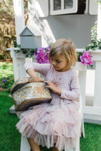 Load image into Gallery viewer, A girl in the garden with her Thandana mini deck insulated cooler bag with a leather handle and gunmetal zipper.
