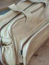 Load image into Gallery viewer, Close-up of Thandana leather baby nappy bag with stitching details on a wooden surface. Hand made in South Africa.
