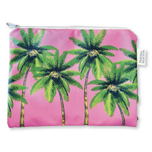 Load image into Gallery viewer, The &quot;Wild Oasis&quot; wet bag by Natural Selection is a pink crepe pouch adorned with green palm trees, featuring a white zipper and tag, ideal for post-beach use.
