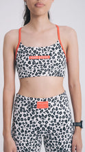 Load image into Gallery viewer, Person wearing a leopard print sports bra and leggings with &#39;Koko Active&#39; branding on a white background
