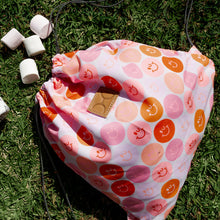 Load image into Gallery viewer, Thandana Drawstring bag with smiley face pattern on grass with marshmallows
