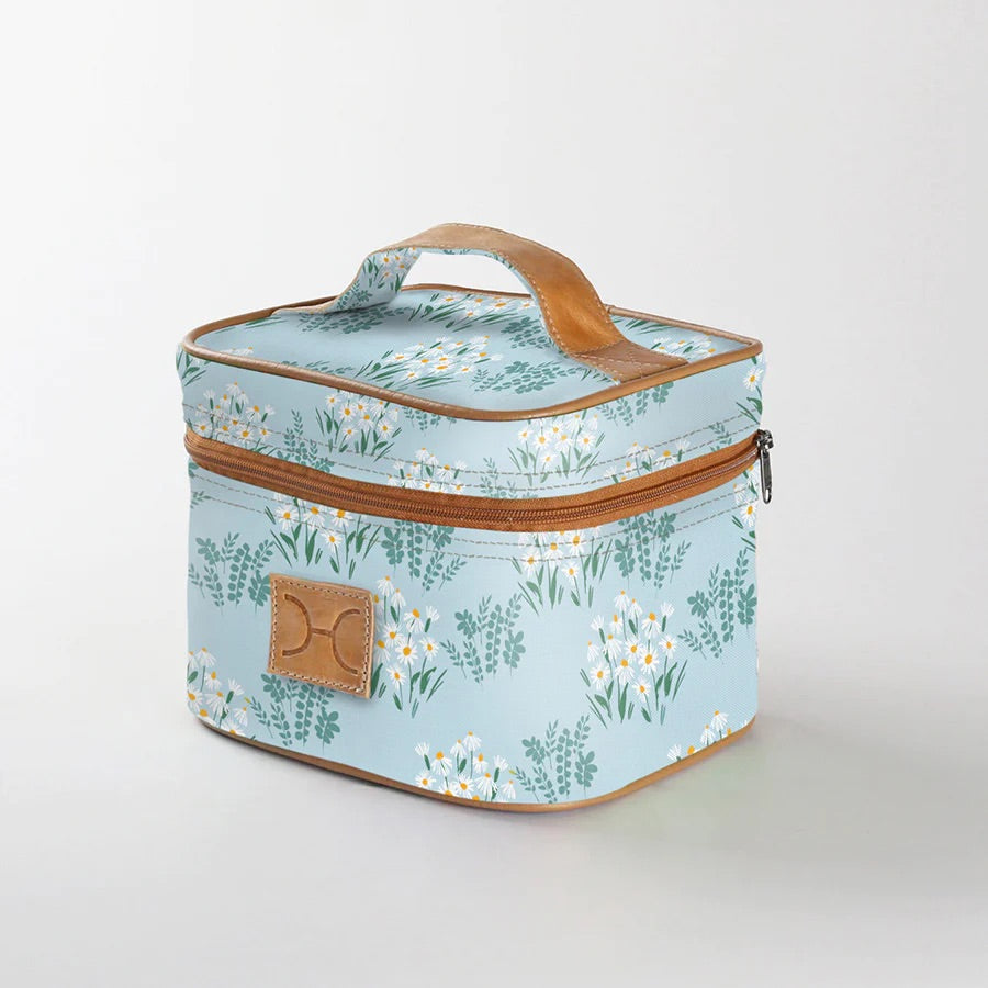 A blue floral patterned Thandana mini deck cooler bag with a genuine leather  handle and brown leather trims.