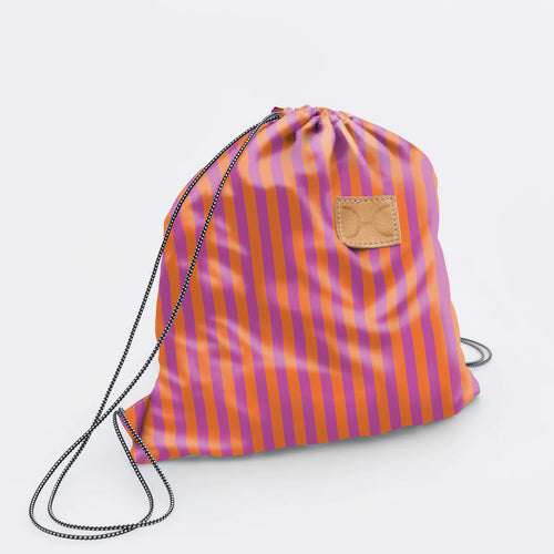Thandana Drawstring bag with pink and orange stripes on a light grey background