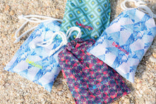 Load image into Gallery viewer, Bobums UAE Microfibre Beach towels inside material bags on sand
