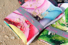 Load image into Gallery viewer, Folded Bobums UAE Microfibre beach towel with Sorbet Snails design
