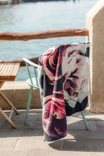 Load image into Gallery viewer, Bobums UAE Microfibre beach towel with Vintage Rose design on chair at Dubai Creek
