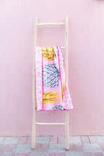 Load image into Gallery viewer, Bobums UAE Microfibre beach towel with Wild Pines design on ladder in front of pink wall at Tania&#39;s Teahouse
