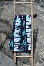Load image into Gallery viewer, Bobums UAE Microfibre beach towel with Blue Palms Kids design on ladder
