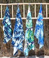 Load image into Gallery viewer, Bobums UAE Microfibre beach towels hanging from a ladder in front of grass at Black Palace Beach
