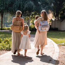 Load image into Gallery viewer, Parents enjoying a walk with kids, both carrying practical backpack diaper bags from Thandana. 
